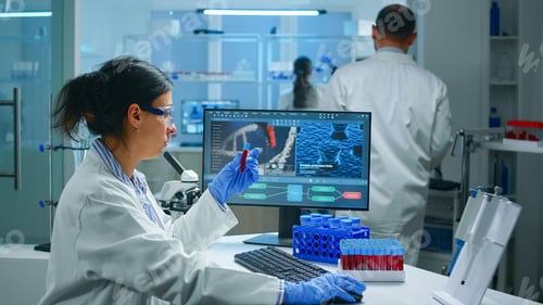 Preview: Group of scientists working in laboratory examining biochemistry sample
