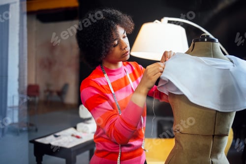 Preview: A young African stands next to a dressmaker mannequin