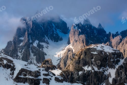 Preview: a mountain range that has some very small rocks and snow on top