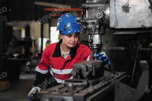 Preview: Industrial worker inspecting and check up machine at factory machines.