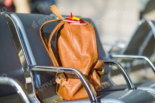Preview: Closeup passports and airplane model on backpack at airport