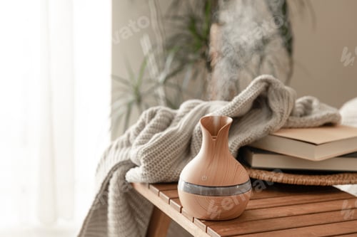 Preview: Aroma oil diffuser lamp on a blurred background in the interior of the room.