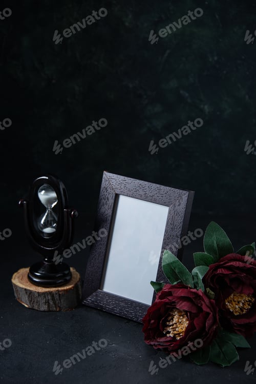 Preview: front view of picture frame with hourglass on dark surface funeral war death time israel evil