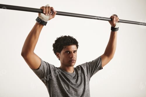 Preview: Portrait of a muscular black athlete grabbing carbon pullup bar