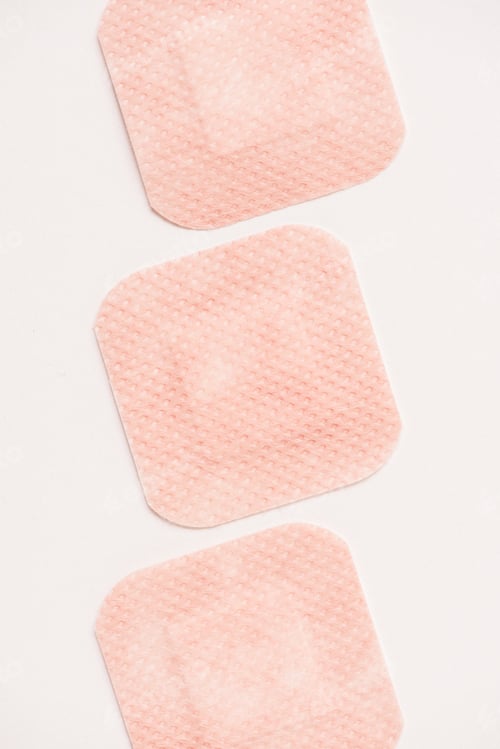 Preview: top view of row of adhesive bandages on white surface