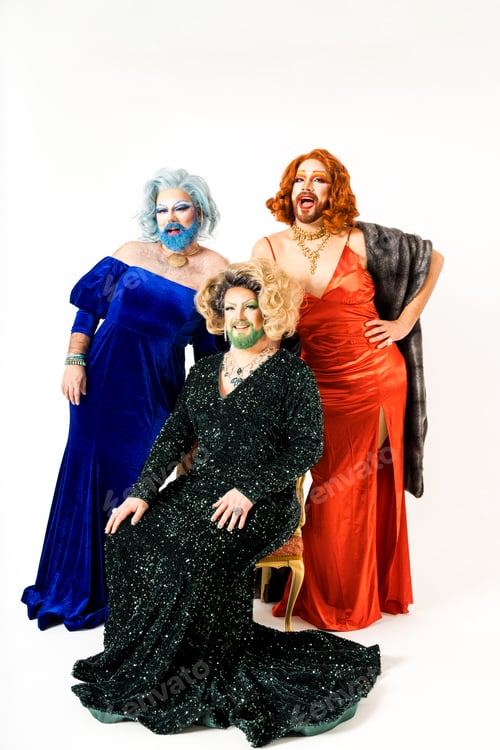 Preview: Three Happy Elegant Drag Queens Posed Against a White Background in Glamorous Attire