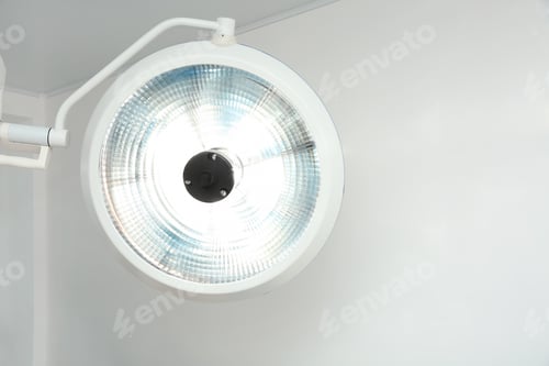 Preview: Bright Operating Room Light Fixture Against White Wall