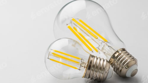 Preview: Light bulbs with visible filaments on a plain background for home lighting use