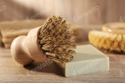 Preview: Cleaning brush and soap bar on wooden table, closeup