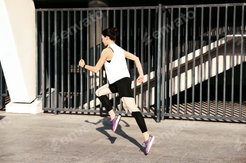 Preview: Beautiful sporty young woman running on street
