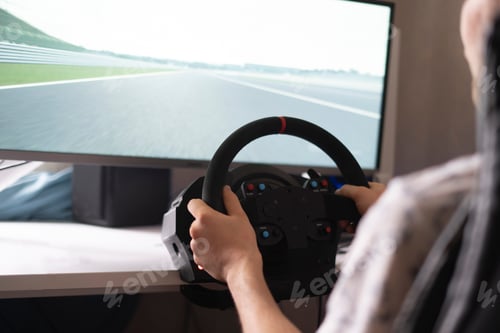 Preview: a person improving his driving skills, race simulator with steering wheel and pedals