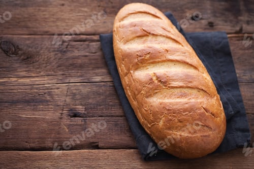 Preview: Fresh bread on wooden table. Top view with space for your text