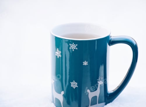 Preview: A mug with hot tea on a snow