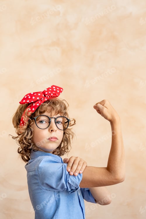 Preview: Child flexes muscles wearing glasses and hair ribbon