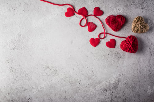 Preview: Red yarn heart shaped on the wall background