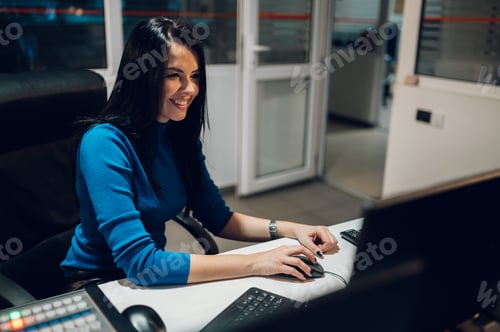 Preview: Middle aged woman using equipment in control room on a tv station