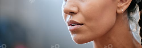 Preview: Closeup banner of a womans face, mouth and chin with blurred copy space. Young female looking confi