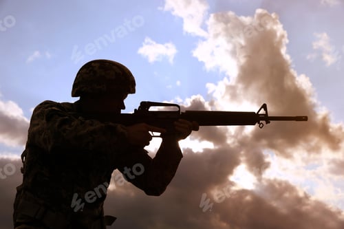 Preview: Soldier with machine gun patrolling outdoors. Military service
