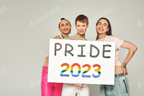 Preview: diverse and young lgbtq community friends with tattoos standing in colorful clothes and holding