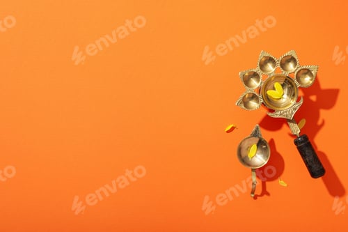 Preview: Copper oriental utensils on orange background, space for text