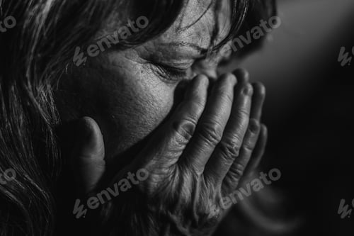 Preview: Close-up of unhappy elderly woman, black and white photo.