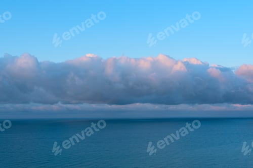 Preview: Nature background with blue sea against cloudy sky during beautiful sunrise. Beauty of nature