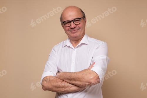 Preview: Smiling senior man looking at camera being confident