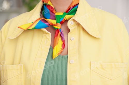 Preview: Woman wearing neckerchief in LGBT colors indoors, closeup