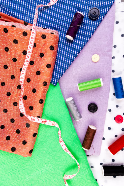 Preview: Items for sewing clothes. Sewing buttons, spools of thread and cloth. Top view.