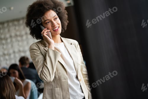 Preview: Close up portrait of beautiful young african woman with phone