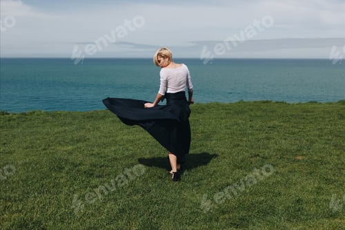 Preview: stylish beautiful girl posing on majestic cliff, Etretat, Normandy, France