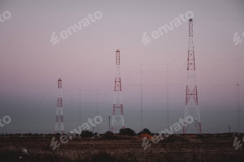 Preview: Tall electric posts in field