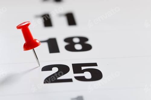 Preview: Pin pushed on a calendar concept for an important day.