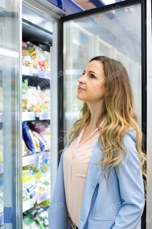 Preview: Women Choosing A Dairy Products At Supermarket. Reading Product Information