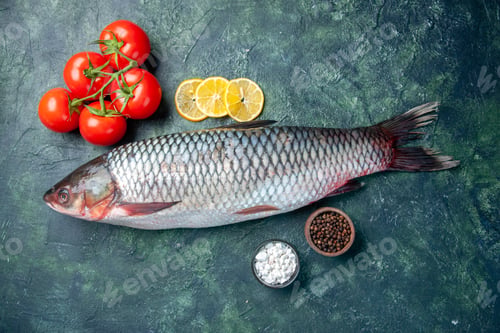 Preview: top view fresh raw fish with tomatoes and lemon on dark blue background shark seafood meal ocean