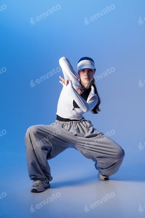 Preview: Modern jazz funk dancer in wide pants posing in studio