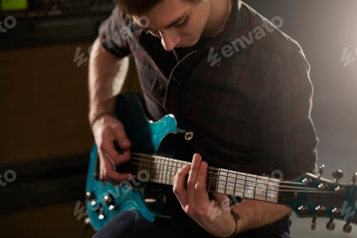 Preview: Man Playing Electric Guitar In Studio