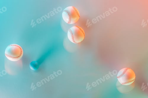 Preview: motion blue of white and leather softballs near ping pong ball on pink and blue