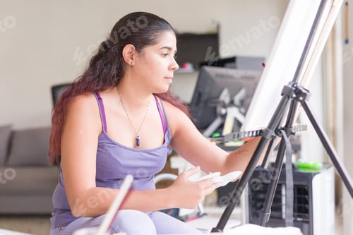 Preview: venezuelan middle aged latin woman. art hobby painting for leisure at home. cheerful apartment