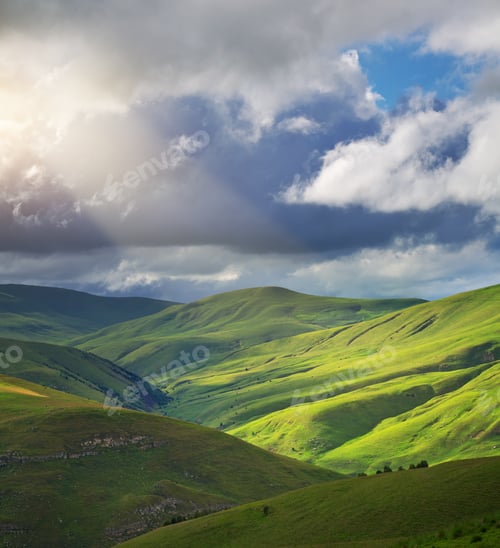 Preview: Green mountain hills and sun rays.