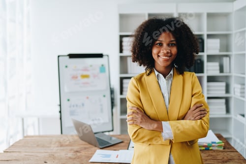 Preview: American African business woman using document, computer laptop, calculator, paperwork, documents
