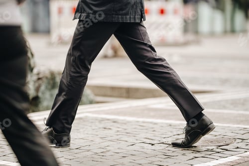 Preview: Businessmen in hurry to reach office in formal black clothes in the day