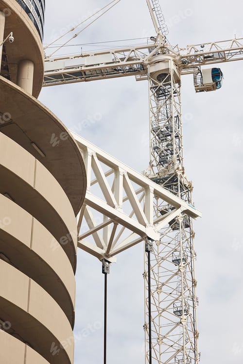 Preview: Telescopic cranes under a white sky. Construction industry
