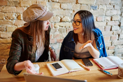 Preview: Happy women having conversation in cafeteria