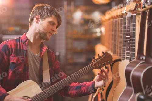 Preview: Young musician playing the guitar