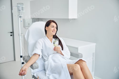 Preview: Happy adult patient relaxing during the intravenous therapy