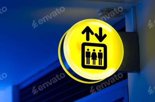 Preview: Bright yellow lift or elevator symbol, sign on blue wall background with neon light. Copy space