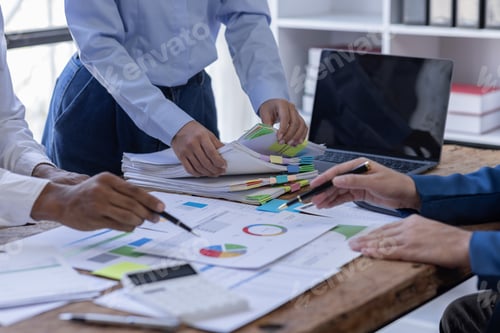 Preview: Team of confident business people point to graphs and charts to analyze market data, balance sheet,