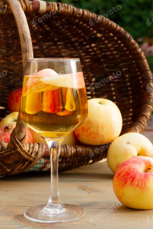 Preview: A glass of apple wine,cider, juice . Ripe summer apples are lying nearby