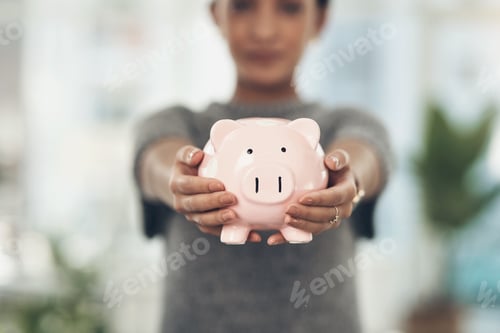 Preview: Woman holding piggy bank for savings concept